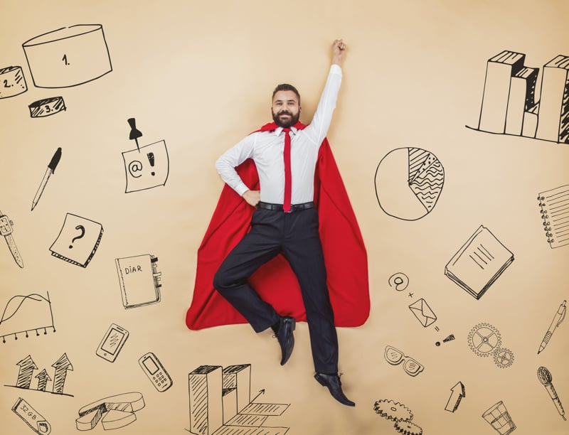 manager-in-a-superman-pose-wearing-a-red-cloak-studio-shot-on-a-beige-background_800